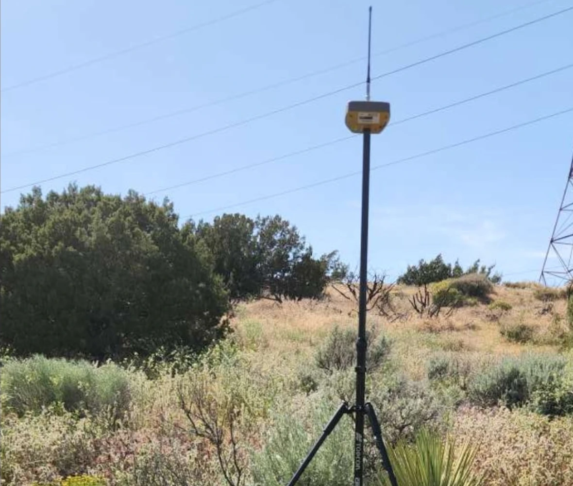 Survey field equipment positioned on natural terrain for site data collection